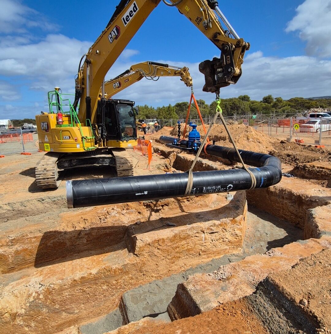 Leed - A large pipe being installed into a right-angle shaped trench by Leed Engineering for the Eyre Peninsula Desalination Transfer Pipeline