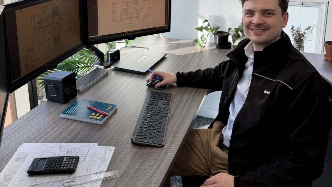 Leed - Leed estimator Jeremy Marks is sitting at his desk in Melbourne. A calculator and engineering drawings are on the desk.
